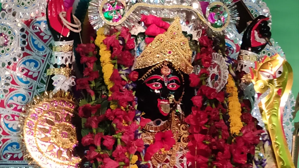 A flower-garlanded Kali image at the Roy Chowdhury family home in Barasat