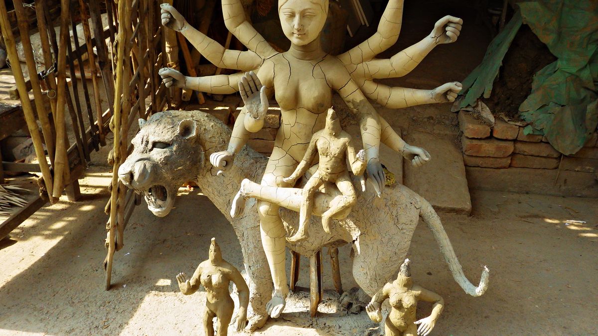 Unfinished clay Durga with her lion and children in a Kumartuli workshop, Kolkata